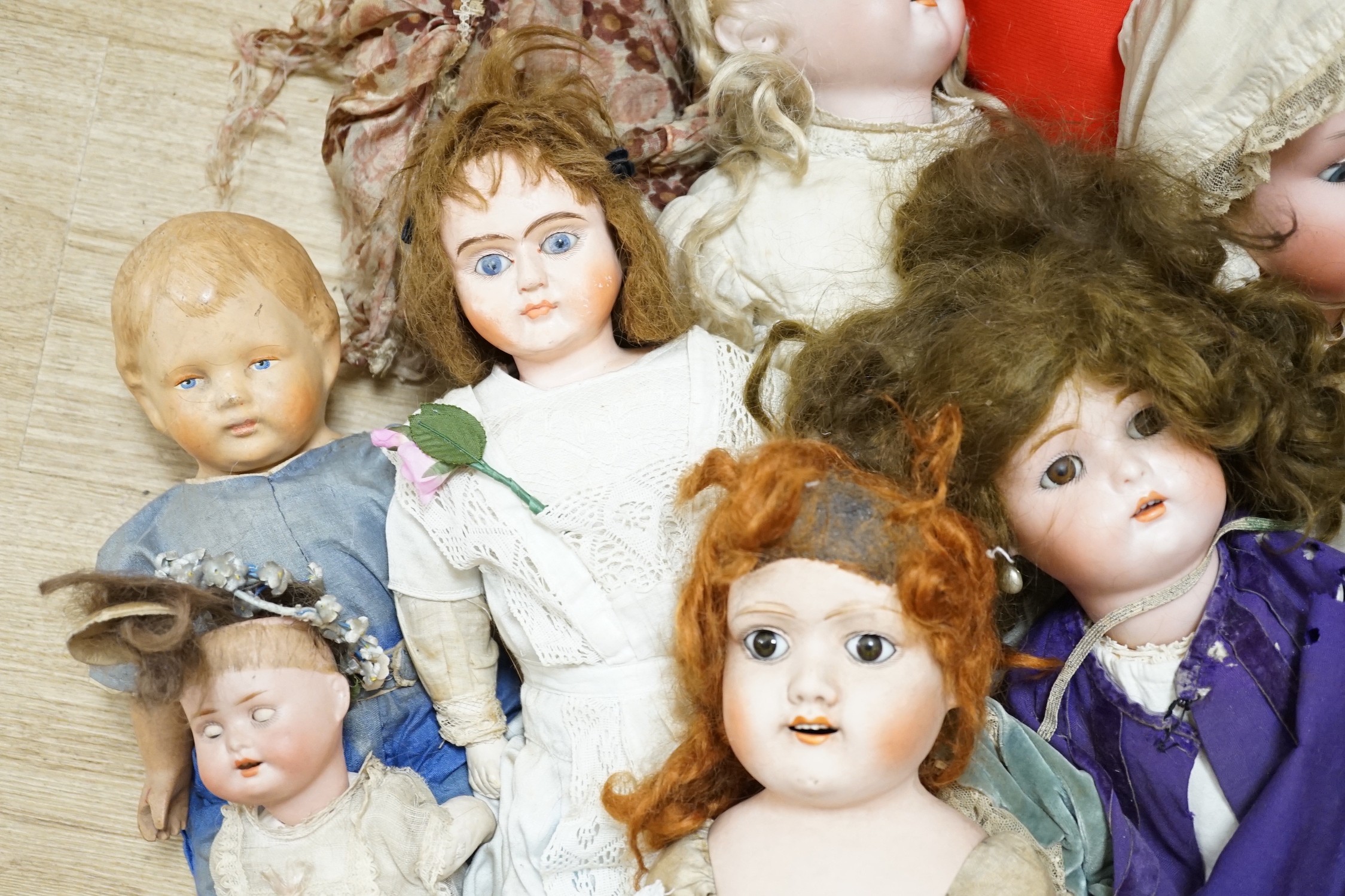 Two Kammer and Reinhardt bisque headed dolls, a wax over composition doll, various other bisque headed dolls and a few single heads and a collection of miniature dolls